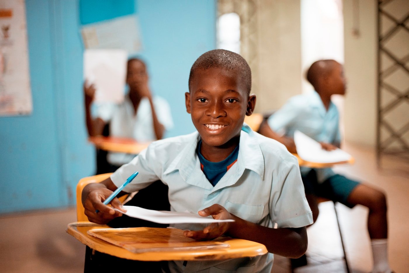 Schoolboy holding a paper after classroom work