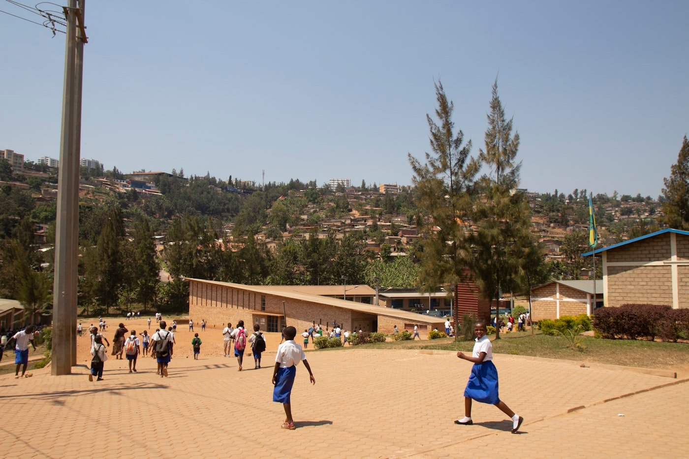 Children running joyfully near a school building